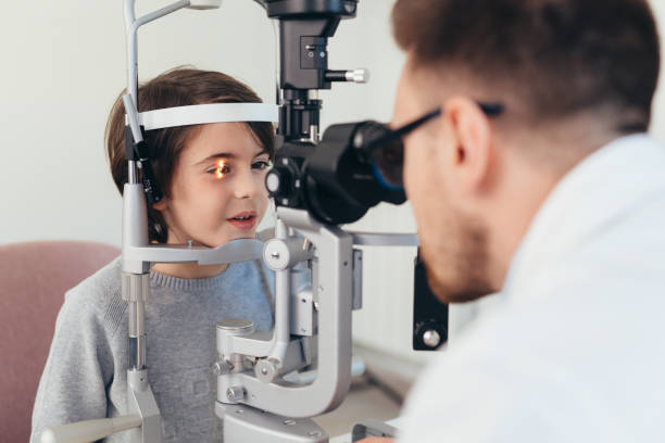 istock boy checking his eyesight in optic clinic 1413541587