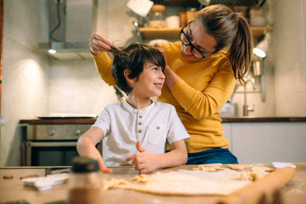 istock boy with her mother preparing cookies 1413541695