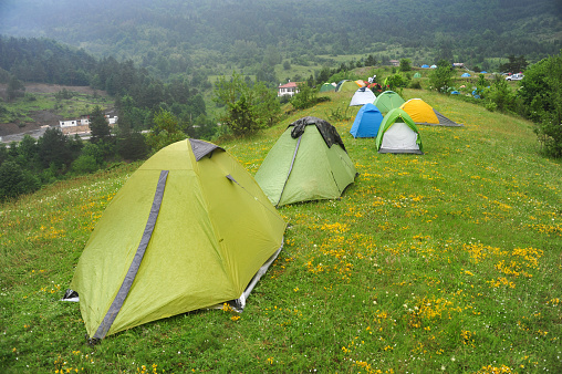 Tent camp on the ridge of a grassy hill