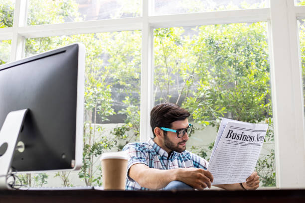 istock Caucasian man reading business news. 1413547577