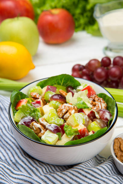 istock Waldorf salad with ingredients on a white wooden table. Selected focus. 1413548844