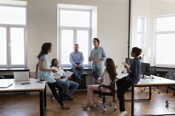 istock Multiracial staff members brainstorming gathered in coworking workspace 1413550786