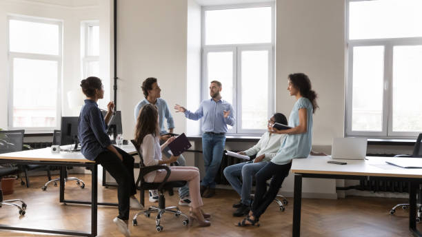 istock Multiethnic staff members gathered in coworking during morning briefing 1413550821