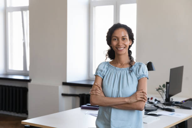 istock Confident African female staff member pose at workplace 1413552409