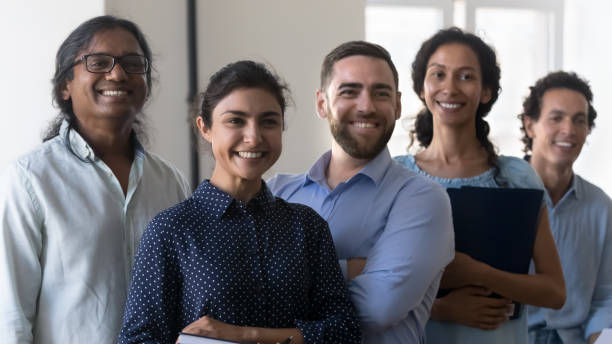istock Five multi racial businesspeople pose in office 1413552410