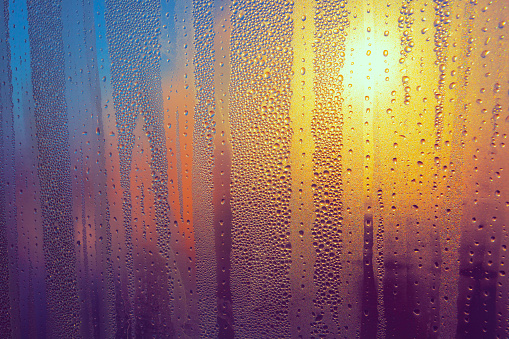Transparent surface with droplets . Water Drops On The Glass . Rain drops in gradient colors