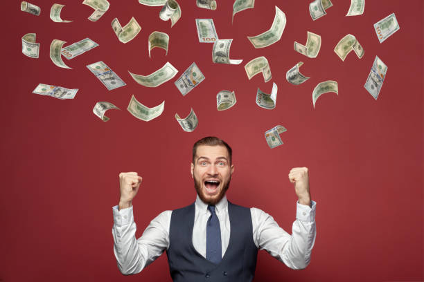 istock Business man with hundred dollar bills on red background 1413553275