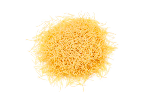 Uncooked vermicelli pasta on white background. Raw dry filini vermicelles. Space for text.