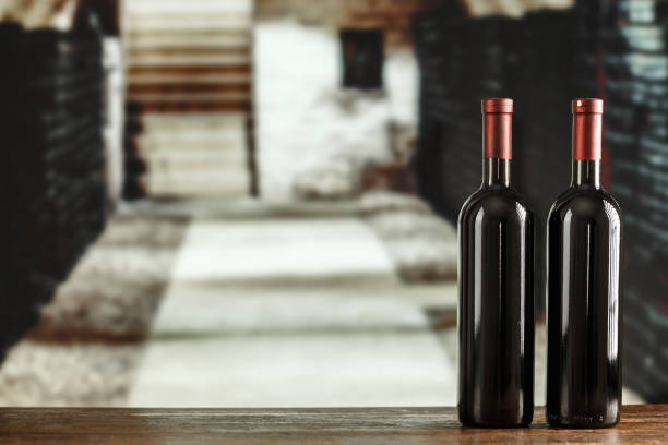 istock Wine cellar with wine bottle and glasses. Red wine tasting in the wine cellar. 1413554089