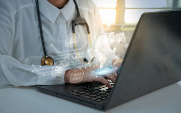 istock Hands of Female doctor with stethoscope working and typing on laptop interface data at medical office. 1413554164