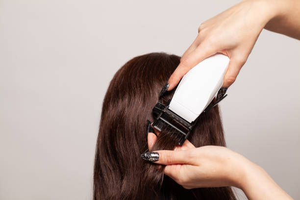 istock Hairdresser cut off split ends with a clipper, closeup 1413555249