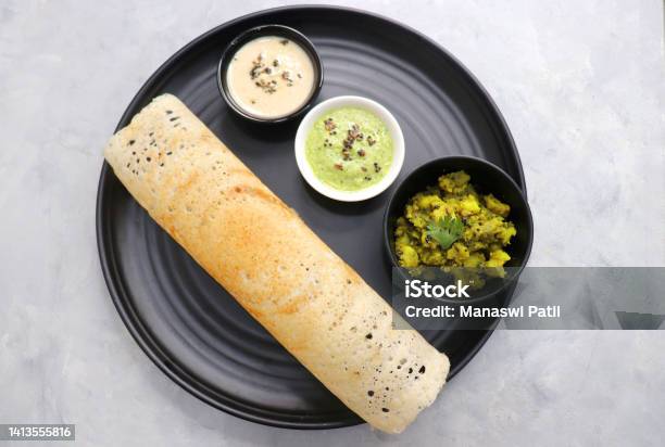 Crispy Masala Dosa Is A Popular South Indian Food Item Served With Tomato Chutney Coconut Chutney Spicy Potato Masala Or Aloo Ki Sabzi And Sambar Copy Space Crunchy Rice Crepes Stock Photo - Download Image Now