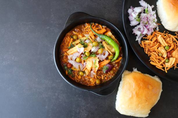 Spicy Misal Pav or usal Pav is a traditional snack or Chaat food from Maharashtra, India. Served with chopped onion, lemon wedges and farsan. Selective focus with copy space Spicy Misal Pav or usal Pav is a traditional snack or Chaat food from Maharashtra, India. Served with chopped onion, lemon wedges and farsan. Selective focus with copy space kolhapur stock pictures, royalty-free photos & images