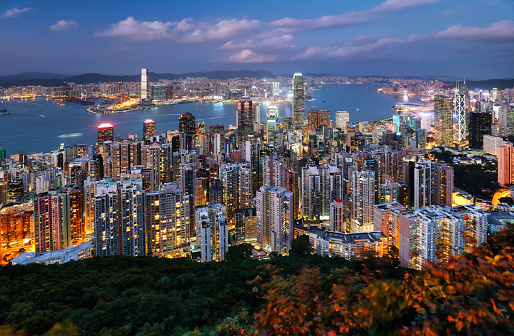 Skyscrapers illuminated at night in Hong Kong, China.