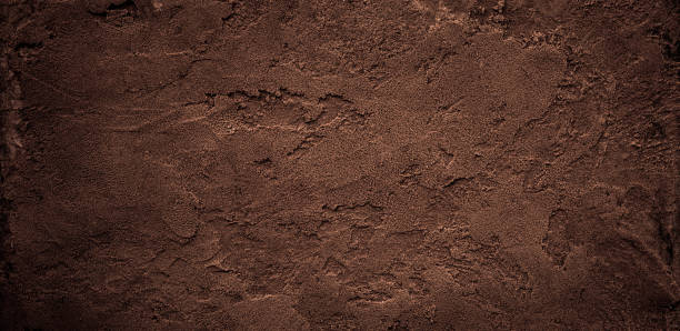 istock Dark chocolate brown sugar-like grainy texture background 1413557059