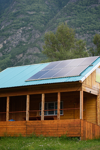solar panels on the roof of a house in the mountains