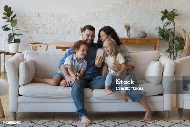 Happy Parents Little Son And Daughter Talking On Video Call Stock Photo - Download Image Now