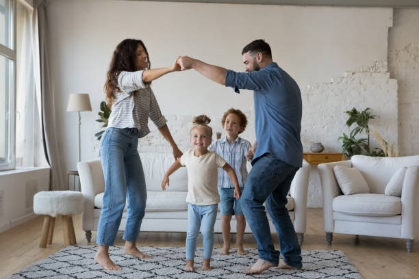 istock Happy active young parents and little kids playing active games 1413558329