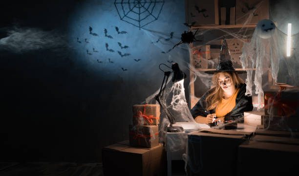 istock A female dropshipping small business owner using a witch costume. Warehouse worker, salesman. Big sale of goods discounts and promotions in honor of Halloween. Banner. 1413558604
