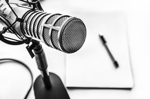 Professional microphone and blank sheet of paper