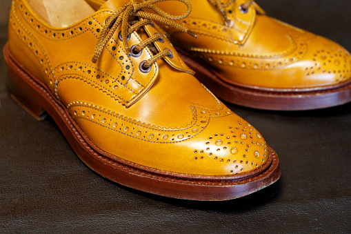Bright brown full brogue leather shoes.