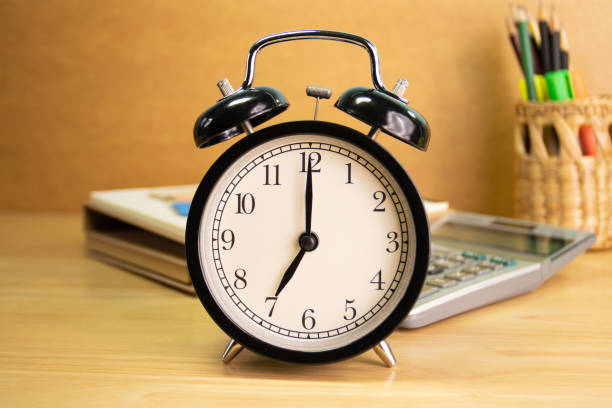 istock 7 AM Clock on work desk in the office Time of business working concepts selective clock 1413562096