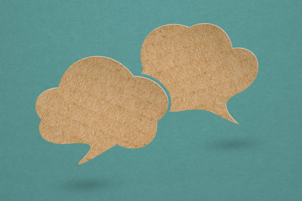 istock two speech bubbles brown cardboard paper cut,  on grunge green background. For message box outline cartoon  illustration design. Balloon doodle style of thinking sign symbol 1413563124