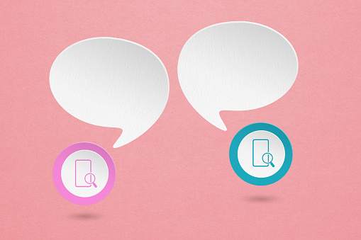 Conceptual image about communication,  search,  and social media, internet. two blank white speech bubble with mobile phone paper cut on grunge pink paper background