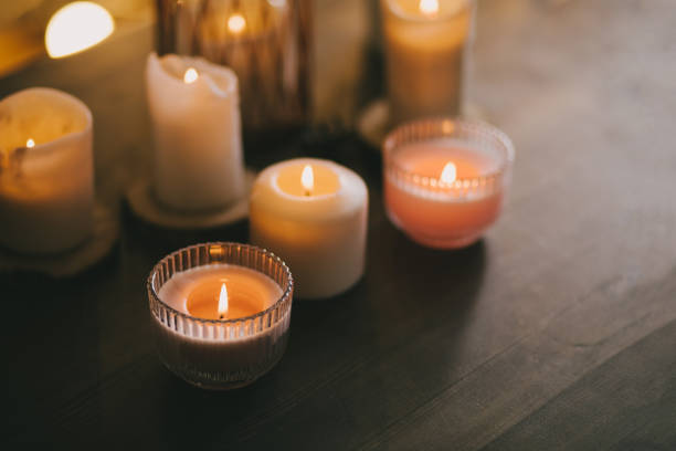istock Candles in glasses on wooden table. 1413565225