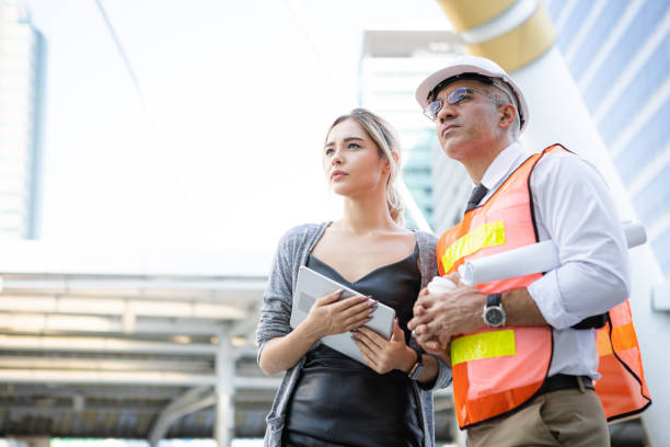 istock Engineers describe details of project to customer. 1413565544