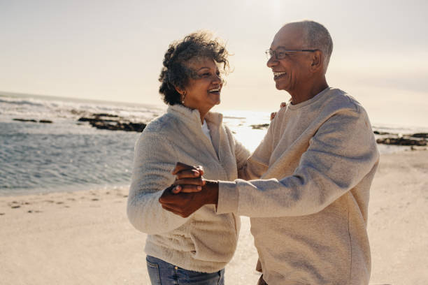 istock Senior couple dancing together at the beach 1413566403