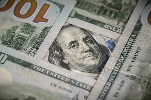 Face of Benjamin Franklin Surrounded by Other $100 Bills