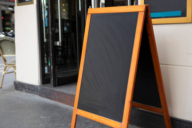 istock Plain chalkboard A-frame sign on a pavement outside a cafe in Paris 1413572250