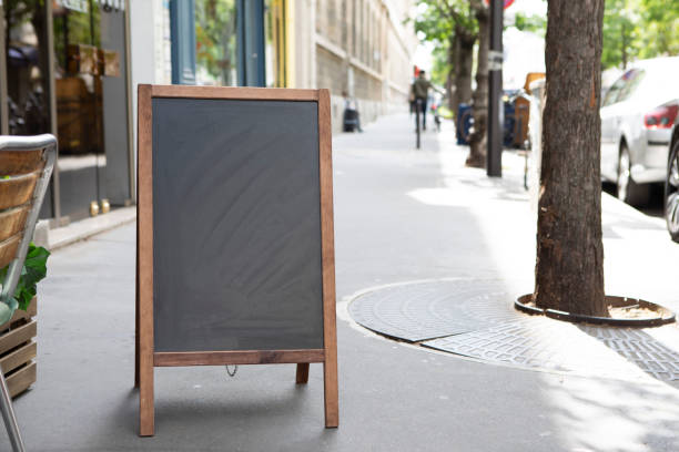istock Plain chalkboard A-frame sign on a pavement outside a cafe in Paris 1413572253