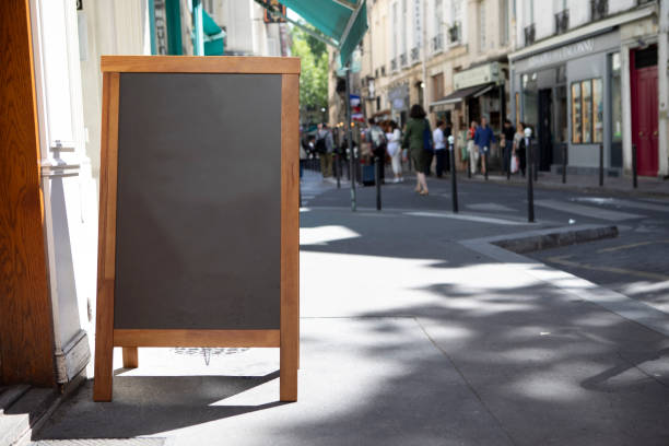 istock Plain chalkboard A-frame sign on a pavement outside a cafe in Paris 1413572354