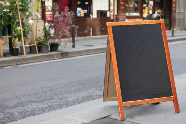 istock Plain chalkboard A-frame sign on a pavement outside a store in Paris 1413572375
