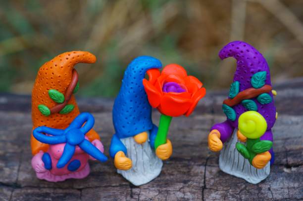 istock Toy gnomes with a flower and a gift. 1413572753