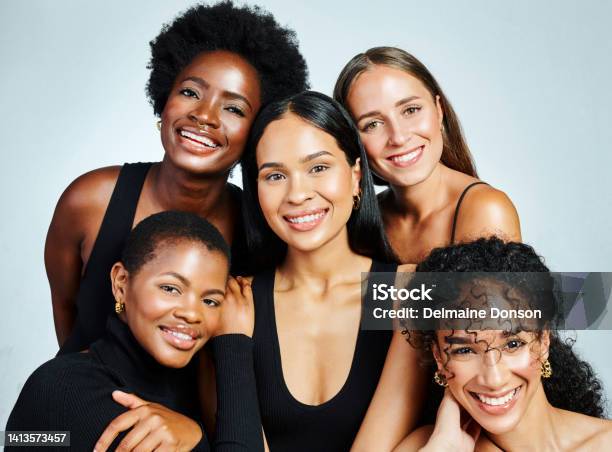Group Of Diverse And Happy Women Showing Beauty Skincare And Cosmetics While Posing Together Against A Grey Studio Background International Female Portrait Of Empowered Women With Bright Smiles Stock Photo - Download Image Now