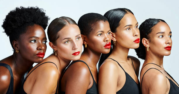 diverse, beautiful and confident women with glowing skin, natural beauty and flawless complexion posing against a studio background. group of serious, international and powerful females - serious african ethnicity mid adult bright imagens e fotografias de stock