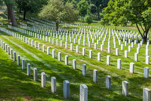 Arlington, USA - July 15, 2010: Gravestones on Arlington National Cemetery in Washington DC, USA. Headstones mark soldier graves who died in every conflict from Revolution to Sept 11.