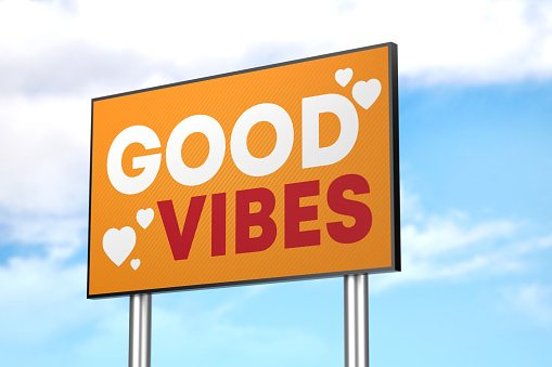 Saying Good Vibes on Billboard on blue sky background. Motivation Concept.