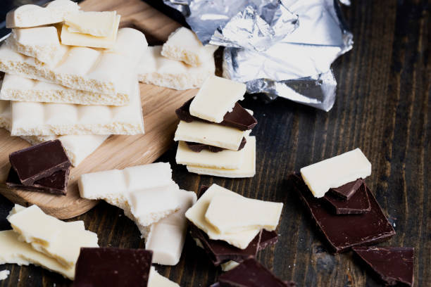 istock broken into pieces tiles of white and milk and dark chocolate 1413577310