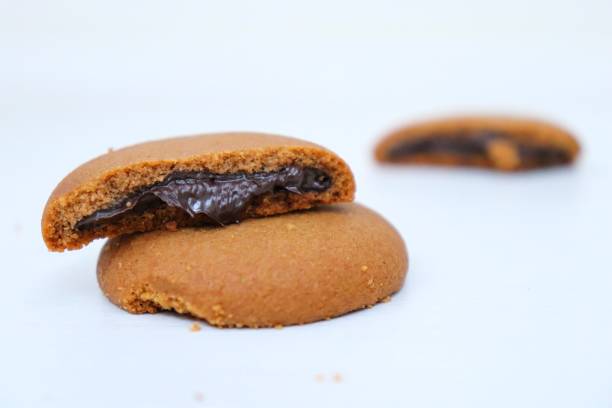 istock Biscuits filled with chocolate cream. Chocolate cream cookies or Choco fills served with cup of Milk 1413580976