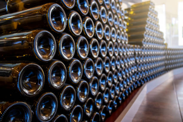 bottles of wine on display in the winery store. texture concept. - wine cellar wine bottle grape imagens e fotografias de stock