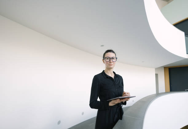 istock Business woman using tablet pc in minimalist office interior 1413581766