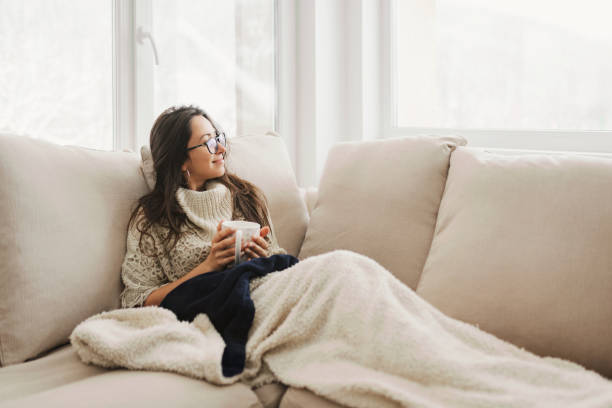 Young caucasian woman enjoying a tea on a cold day