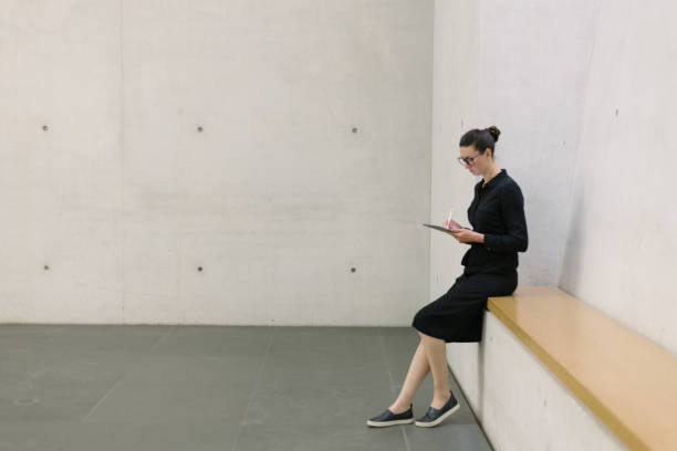 istock Business woman using tablet pc in minimalist office interior 1413581942