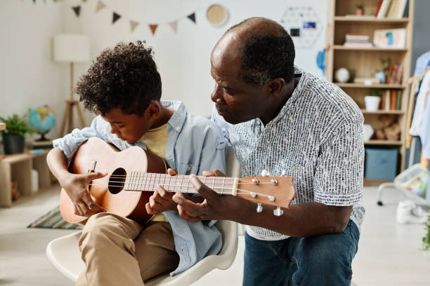 istock Teacher having musical lesson with boy 1413582443