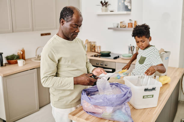 istock Father showing his son hw to sort garbage 1413582726