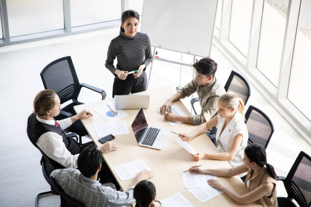 istock Top view of team meeting to analyze assignments. 1413583565